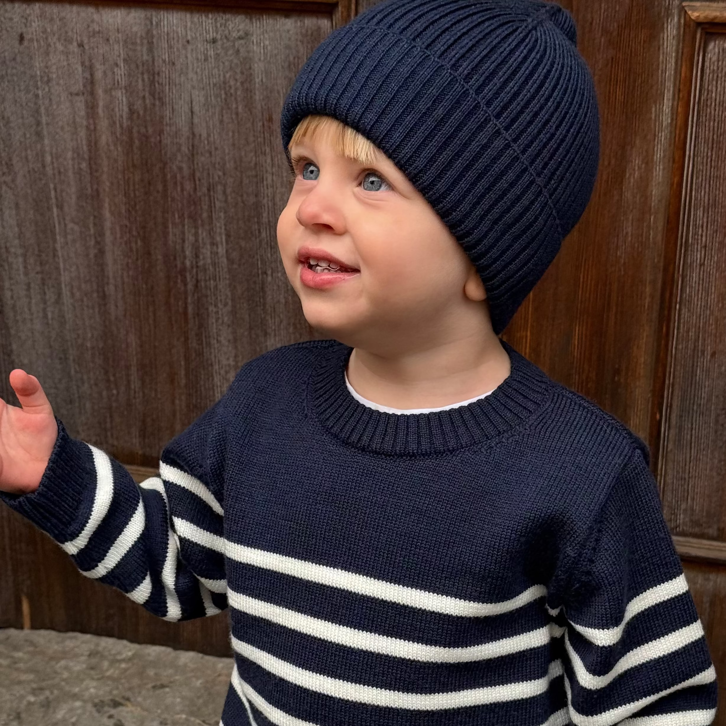 little boy wearing a navy merino wool beanie