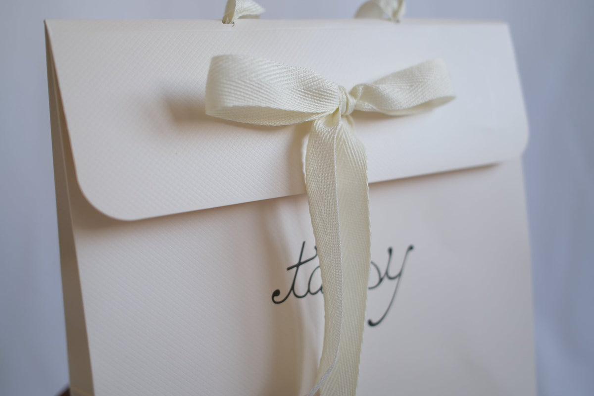TANSY branded cream gift bag for children's knitwear